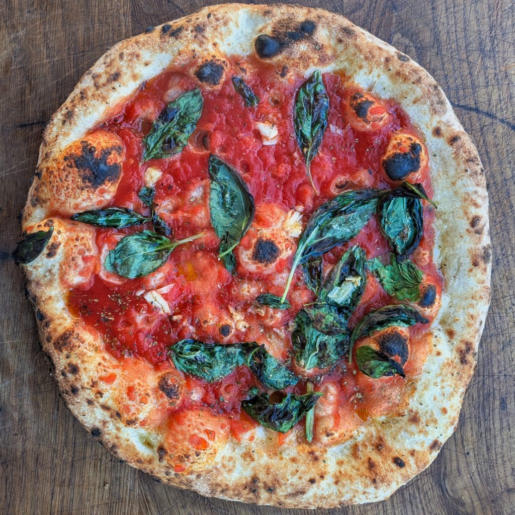 Picture of a vegan marinara wood fired pizza 