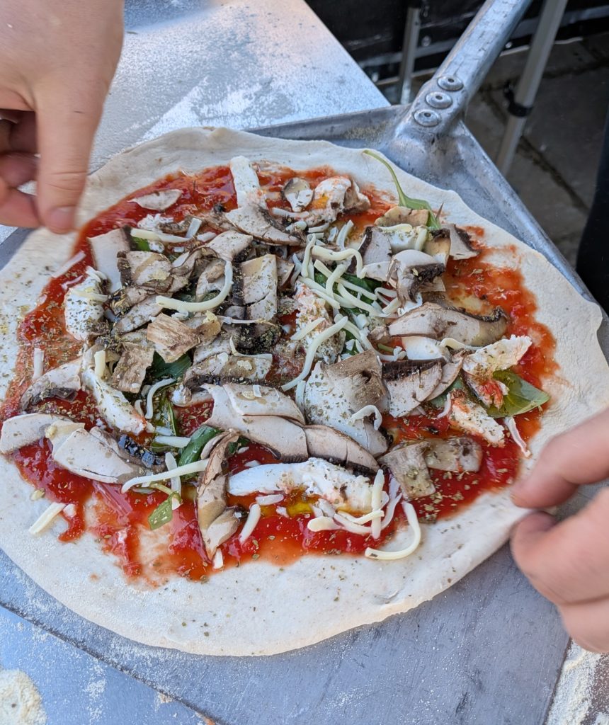 Picture of a portobello pizza on a peel 